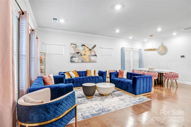 living room featuring recessed lighting, visible vents, crown molding, and light wood-style flooring