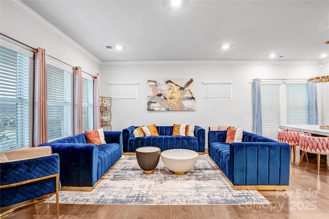 living room with recessed lighting, visible vents, crown molding, and wood finished floors