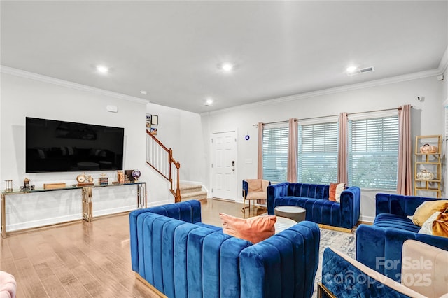 living area with crown molding, recessed lighting, light wood-type flooring, baseboards, and stairs