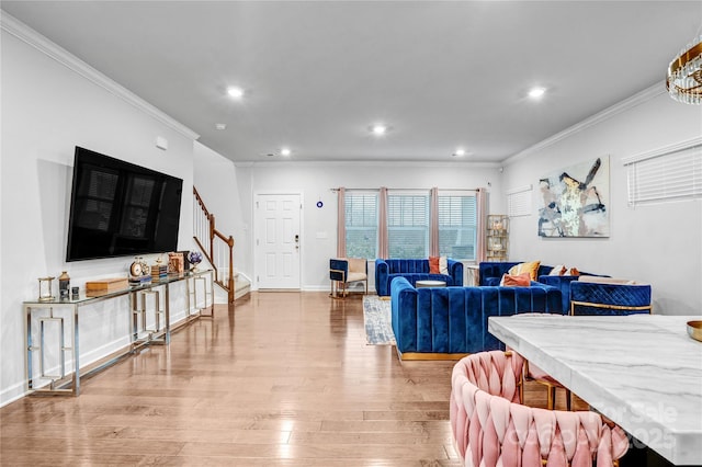 living room with light wood finished floors, recessed lighting, stairway, and ornamental molding