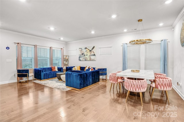 living area featuring baseboards, recessed lighting, light wood-style flooring, and crown molding