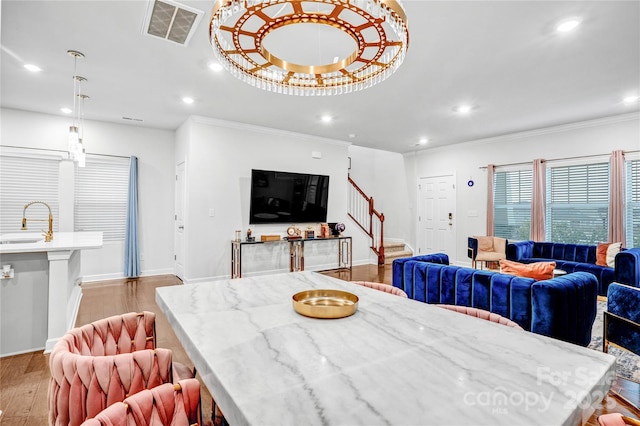 dining room with crown molding, recessed lighting, visible vents, light wood-style flooring, and stairway