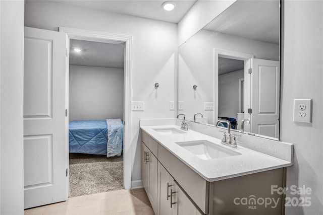 ensuite bathroom with double vanity, ensuite bath, and a sink