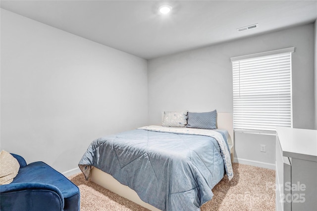 bedroom featuring light carpet, baseboards, and visible vents