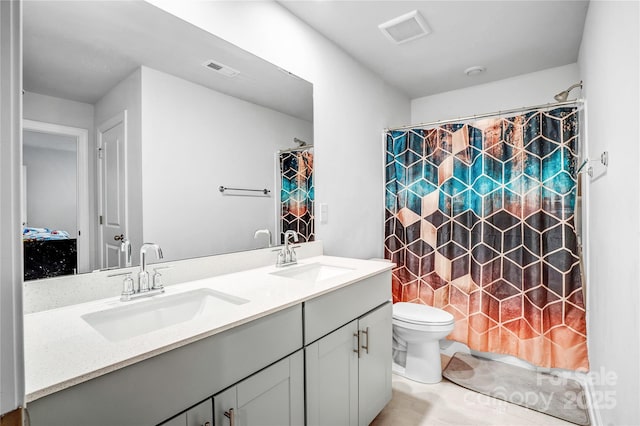 full bathroom featuring visible vents, a sink, toilet, and double vanity