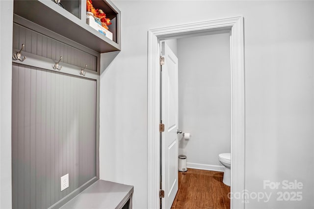 mudroom with dark wood-type flooring and baseboards