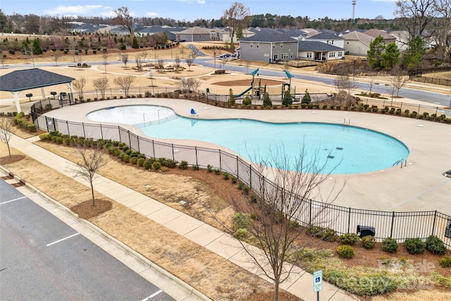 pool featuring a patio area, a residential view, and fence