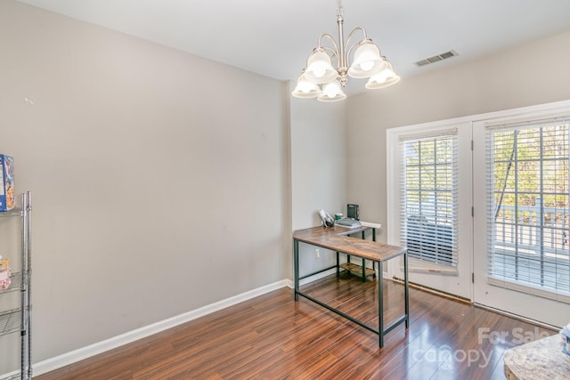 office space featuring a chandelier, dark wood-style flooring, visible vents, and baseboards