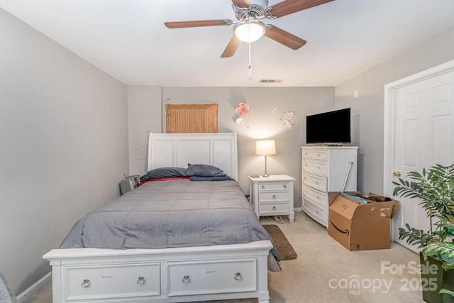 bedroom featuring ceiling fan, visible vents, and light colored carpet