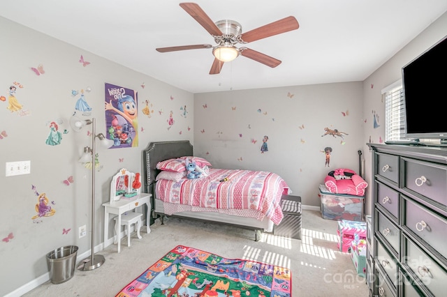 bedroom featuring light carpet, a ceiling fan, and baseboards