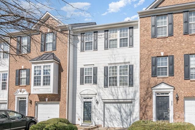 townhome / multi-family property featuring an attached garage