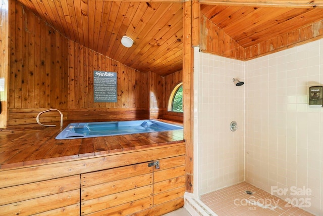 bathroom featuring tiled shower, vaulted ceiling, and wooden ceiling