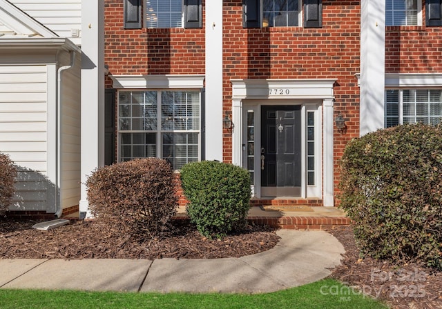 property entrance featuring brick siding