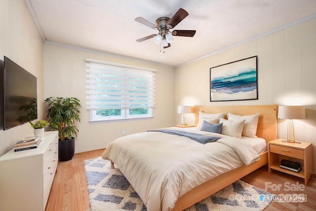 bedroom with ceiling fan, light wood-type flooring, and crown molding