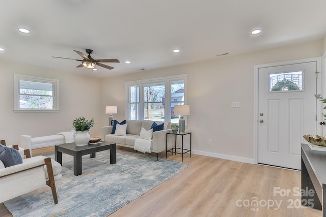 living area featuring plenty of natural light, light wood-style flooring, and recessed lighting