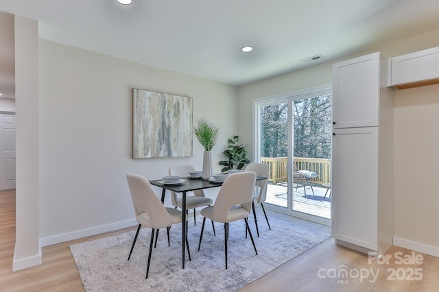 dining space featuring light wood finished floors, recessed lighting, visible vents, and baseboards