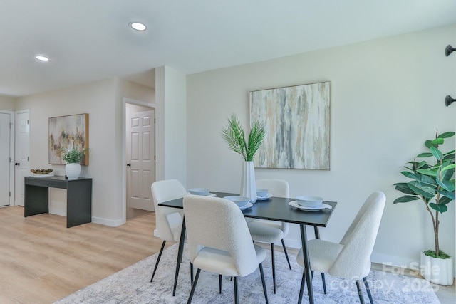 dining area with recessed lighting, baseboards, and light wood finished floors