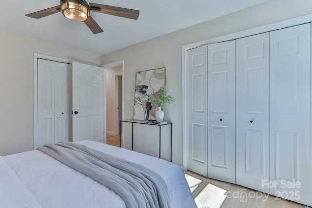 bedroom with two closets and a ceiling fan