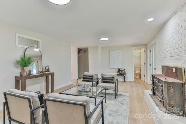 living area featuring baseboards and light wood-style floors