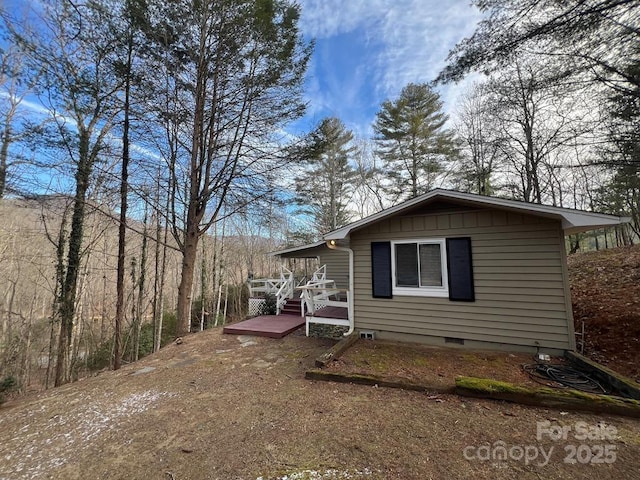 view of side of home featuring a deck