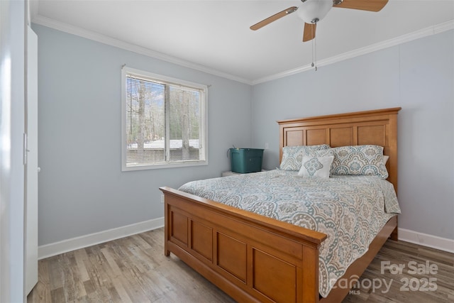 bedroom with ornamental molding, ceiling fan, and light hardwood / wood-style flooring