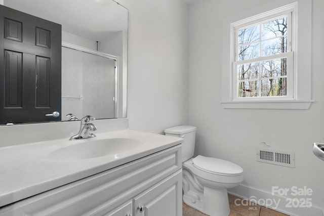 bathroom with visible vents, toilet, a stall shower, vanity, and tile patterned flooring