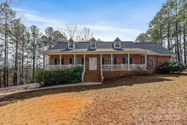 cape cod home with a front lawn and a porch