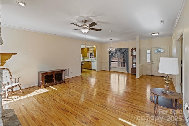 living room with ceiling fan with notable chandelier, light hardwood / wood-style flooring, and crown molding