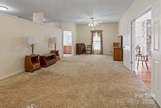 living area featuring ceiling fan and light colored carpet