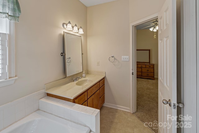 bathroom featuring vanity, a bath, and plenty of natural light