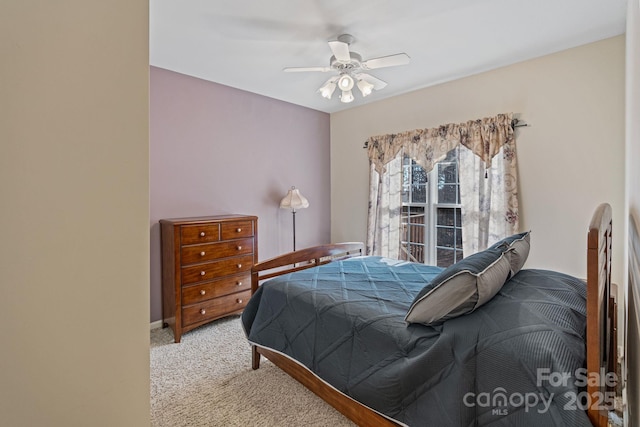 bedroom with ceiling fan and light colored carpet