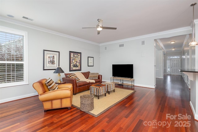 living area featuring visible vents, dark wood finished floors, and baseboards