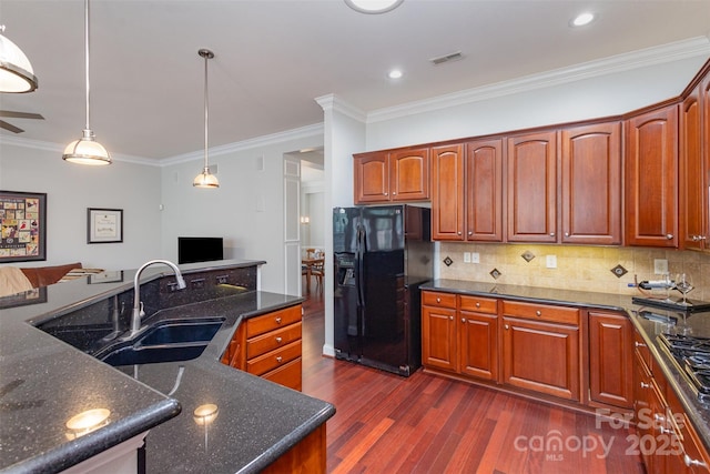 kitchen featuring dark wood-style flooring, decorative light fixtures, a sink, black refrigerator with ice dispenser, and backsplash