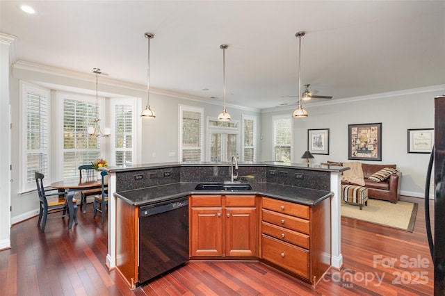 kitchen with a kitchen island with sink, a sink, open floor plan, dishwasher, and pendant lighting