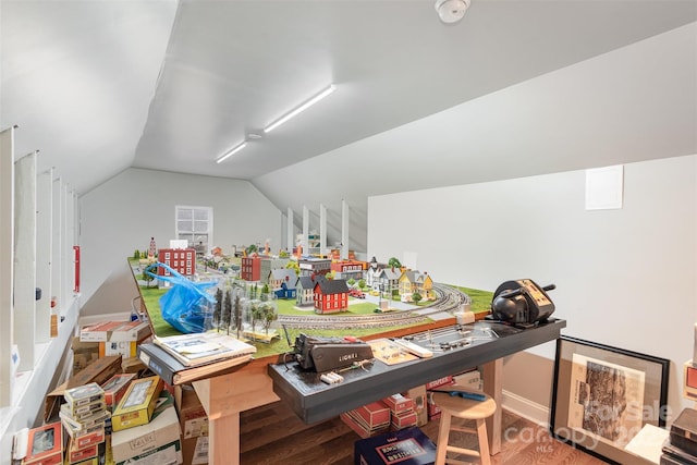 office space with vaulted ceiling and wood finished floors