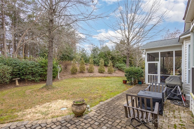 view of yard featuring a patio and a sunroom