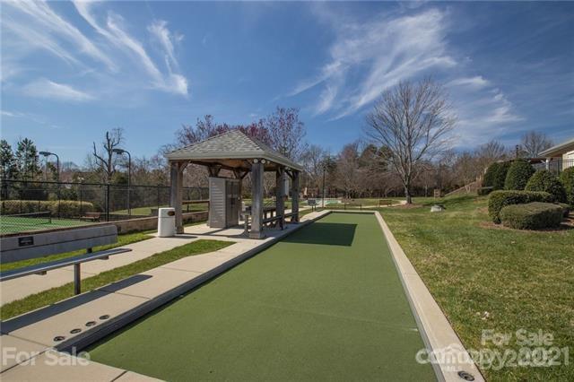 view of property's community featuring a gazebo, a yard, and fence