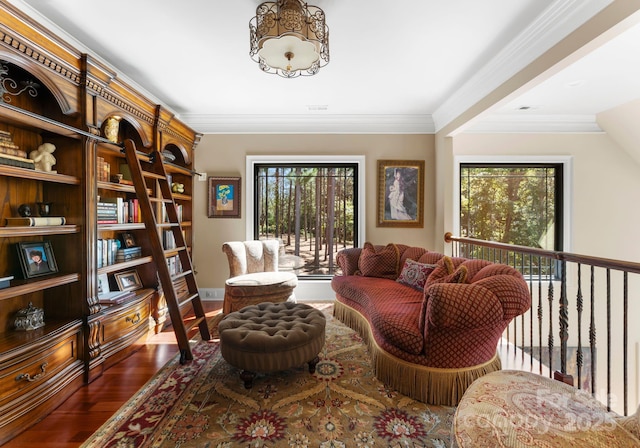 sitting room with crown molding and dark wood-type flooring