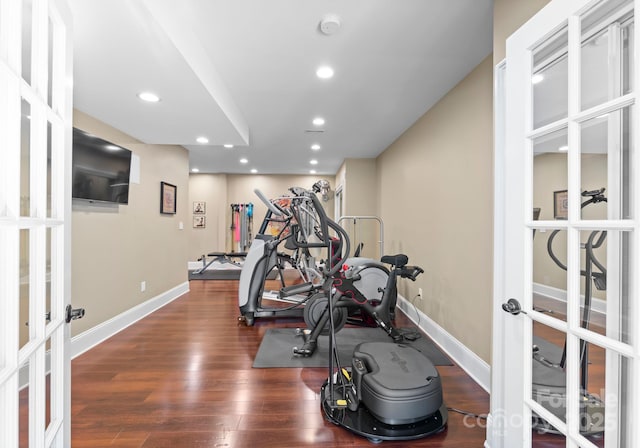 exercise room featuring french doors and dark hardwood / wood-style flooring