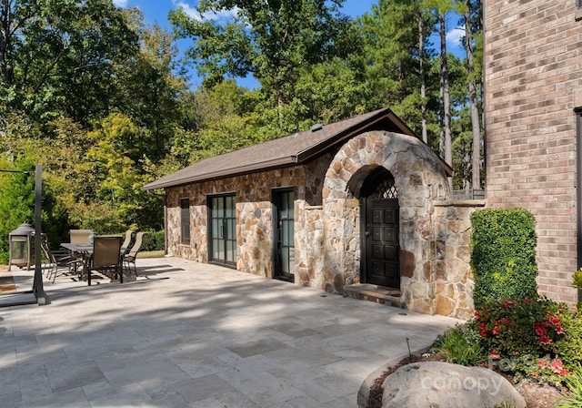 view of patio with an outdoor structure