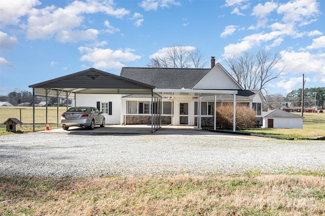 rear view of house featuring a yard and a carport