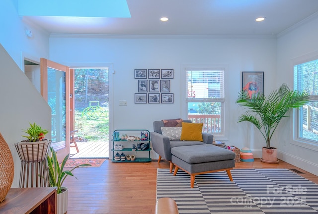 sitting room featuring crown molding, wood finished floors, and recessed lighting