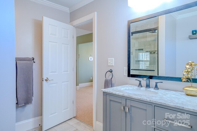 full bath with ornamental molding, tiled shower, vanity, and tile patterned floors