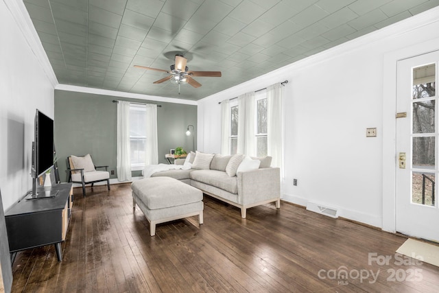 living area featuring a healthy amount of sunlight, visible vents, and dark wood-type flooring