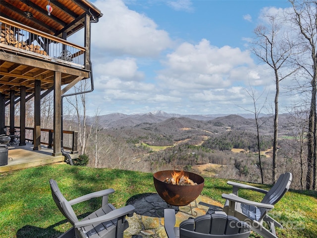 exterior space featuring a fire pit, a patio area, and a mountain view