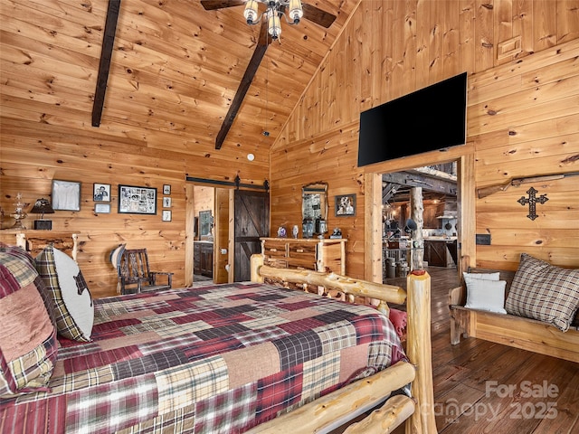 bedroom featuring a barn door, wood walls, wood finished floors, and wood ceiling