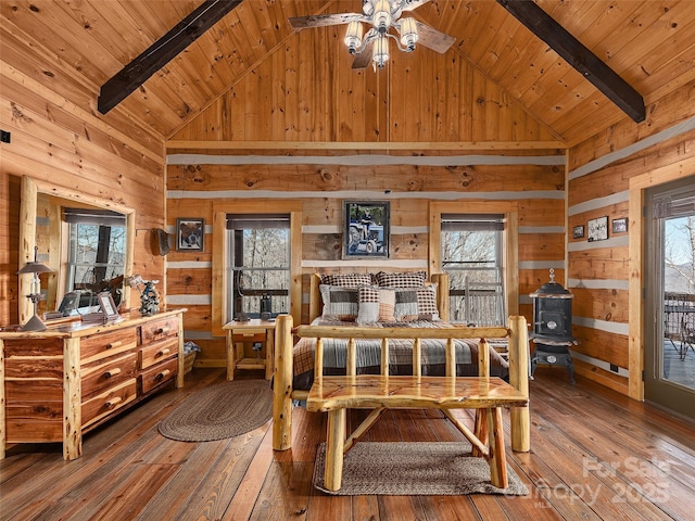 bedroom featuring wood ceiling, wooden walls, and multiple windows