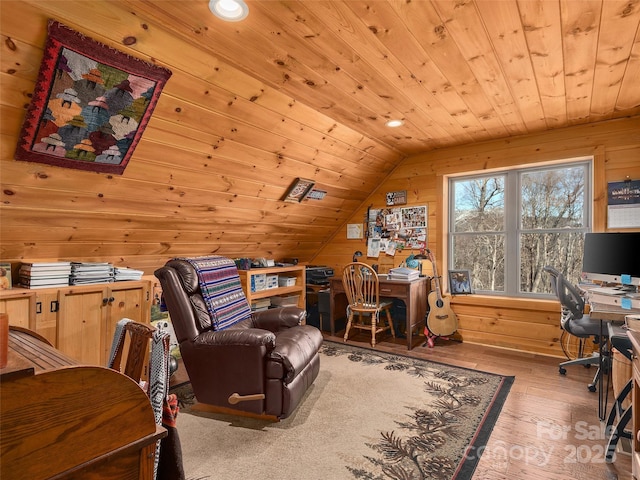 office area featuring vaulted ceiling, wood walls, wooden ceiling, and wood-type flooring