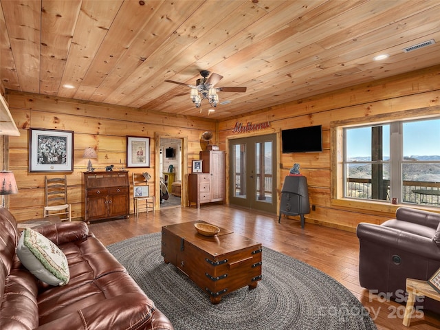 living room featuring wood ceiling, french doors, hardwood / wood-style floors, and visible vents