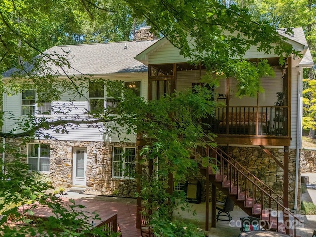 2988 Parks Lafferty Rd, Concord, NC 28025 - rear view of house with stone siding, a deck, and roof with shingles